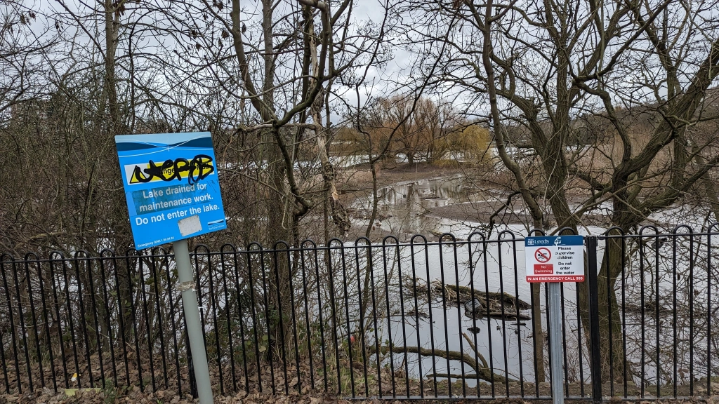 Informative metal sign at the side of Farnley Reservoir has been vandalised with graffiti.